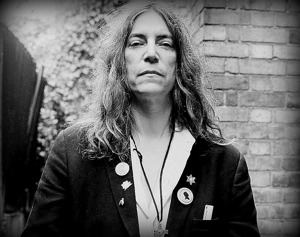 the great Patti Smith, wearing her T and Brie Firefly Pin