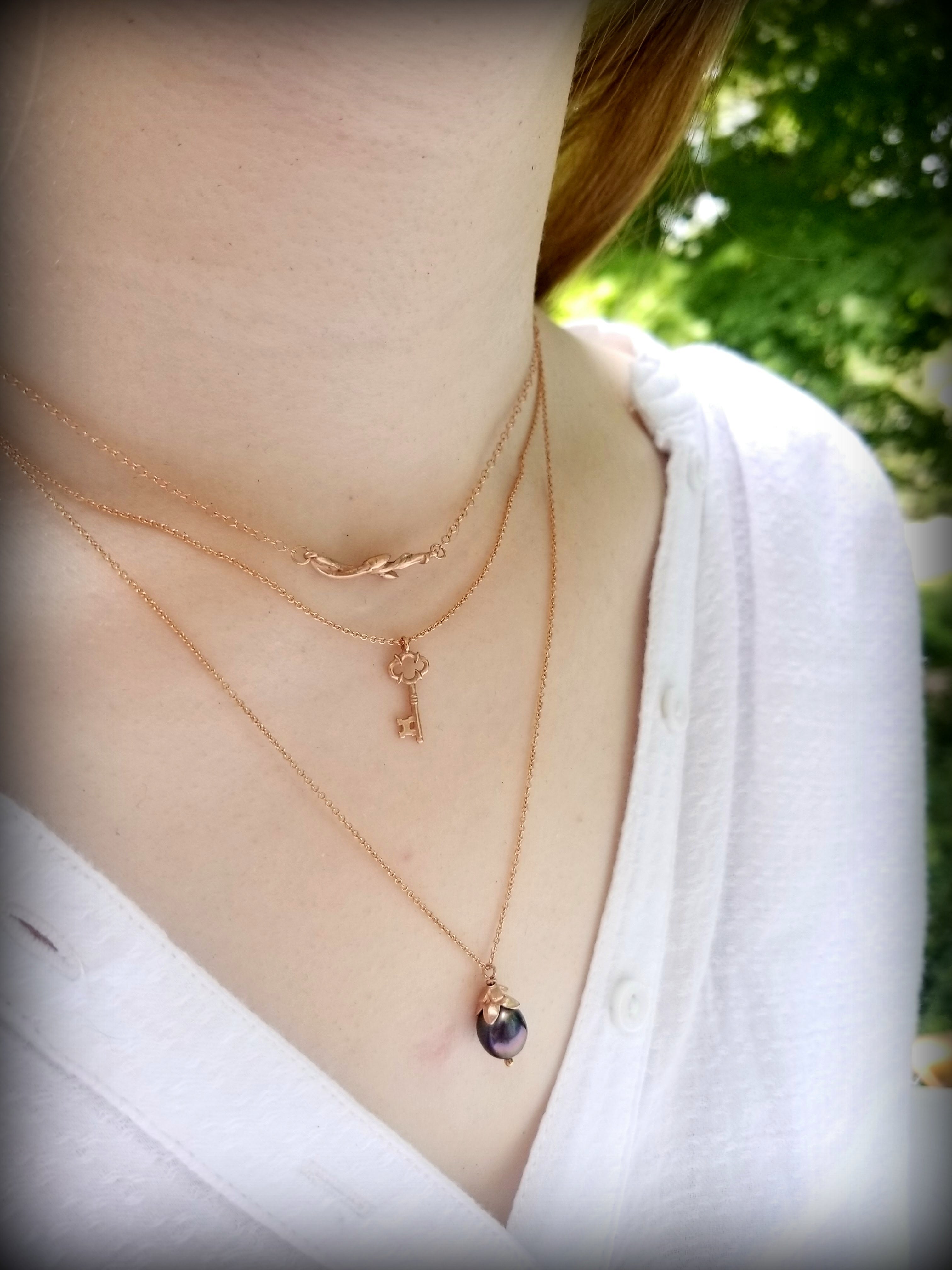 Rose Gold layers handcrafted by T and Brie: Budding Branch Necklace, Cybele Key Charm necklace, Black Dahlia Bud Necklace©Teresa de la Guardia, All Rights Reserved